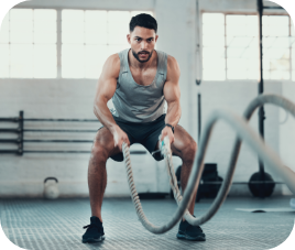 fit man with fit ropes in a gym